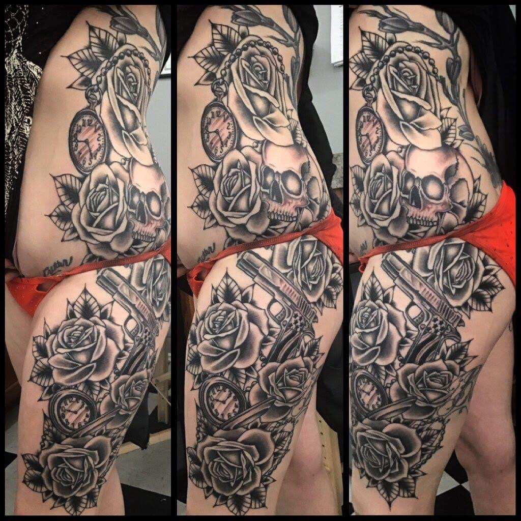 Amazing black and grey roses, skulls, timepiece tattoo on clients ribs and hip area